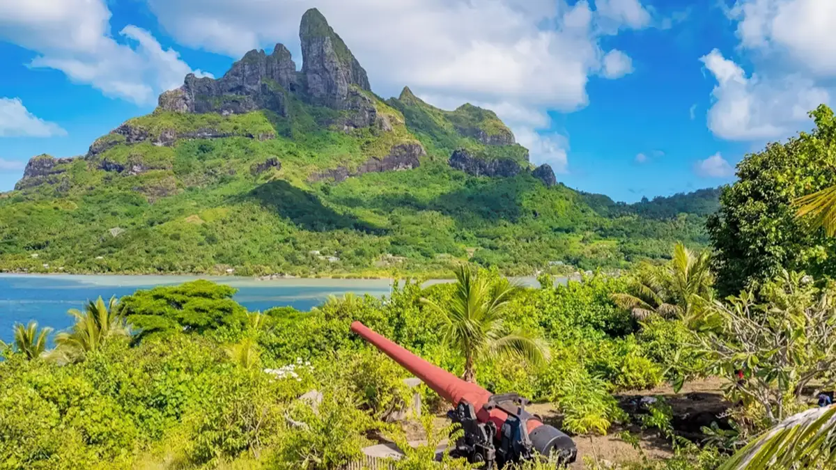 WWII cannon at Anau with Mount Otemanu view in Bora Bora
